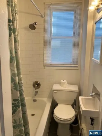 a white toilet sitting next to a bathroom sink