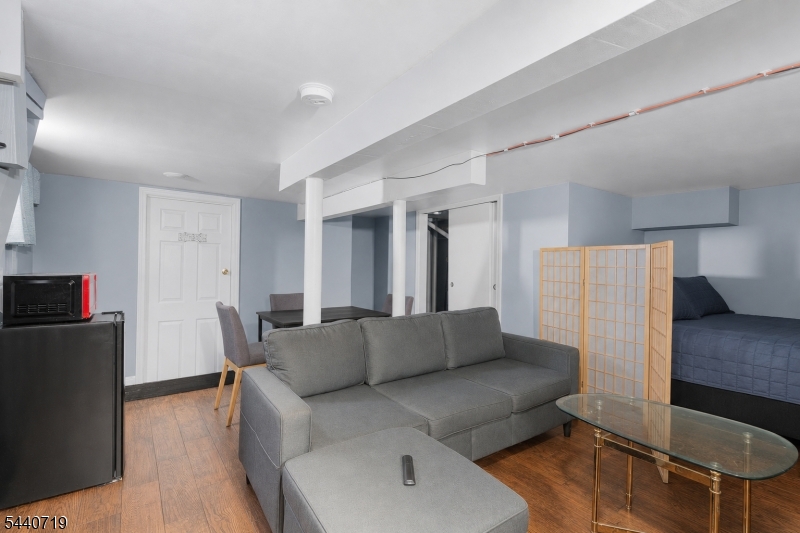 136 Smith Street Elizabeth, NJ 07201 - Photo 35 of 38 a living room with furniture and a refrigerator