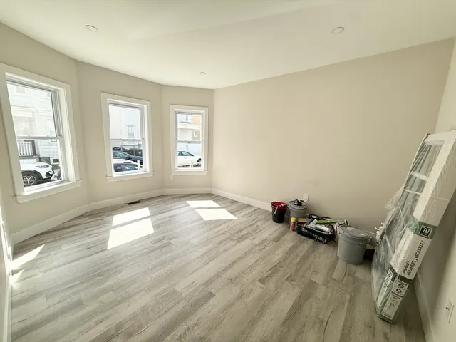 a view of a livingroom with wooden floor and a window