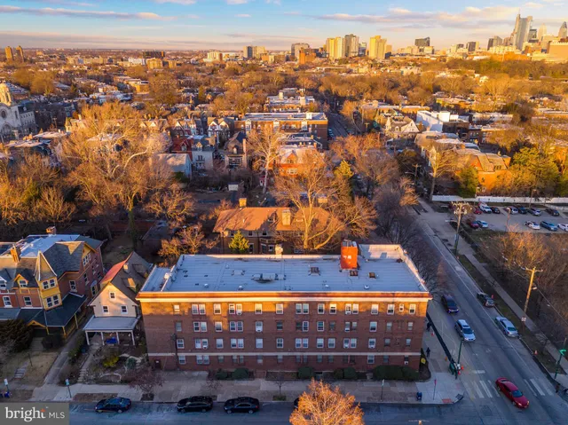 a living room with furniture and a book shelf