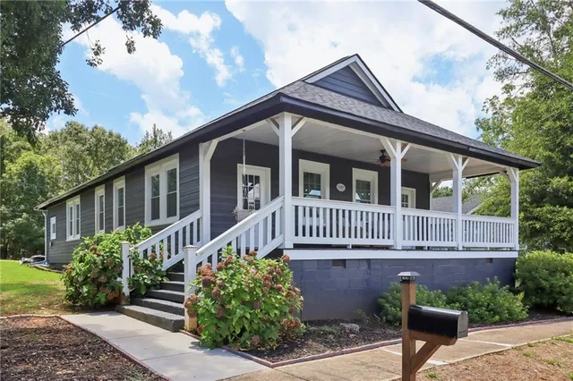 a front view of a house with a garden