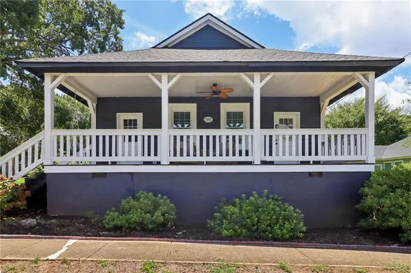 a view of a house with a deck and a garden