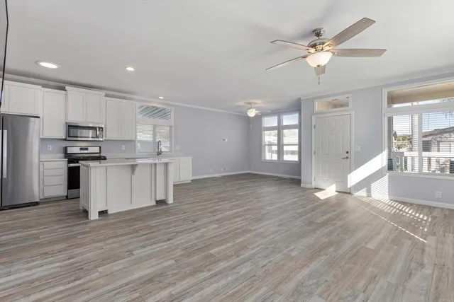 a view of kitchen with sink and wooden floor