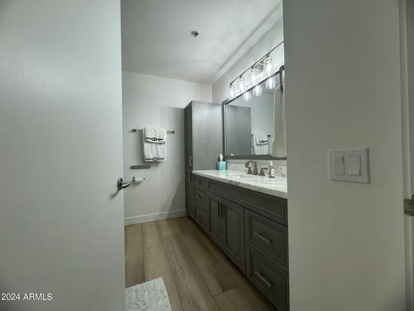 a spacious bathroom with a double vanity sink and mirror