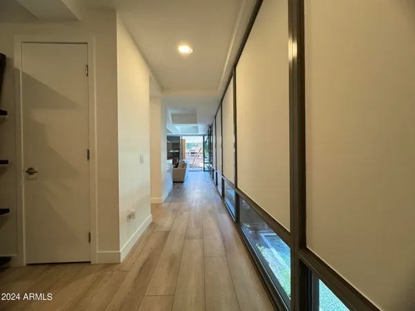 a view of a hallway with wooden floor