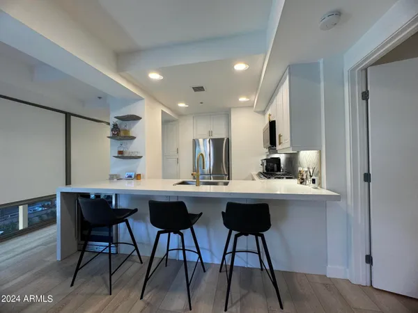 a kitchen with a table and chairs in it