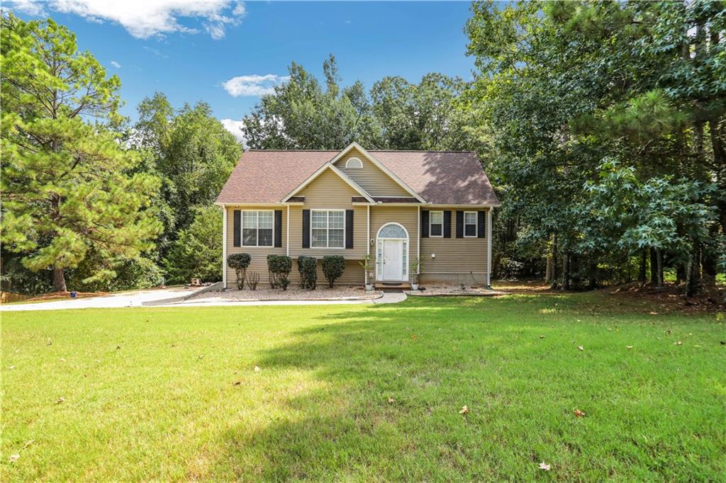 117 Hampton Brook Drive Hampton, GA 30228 - Photo 1 of 1 a house with a garden in front of it