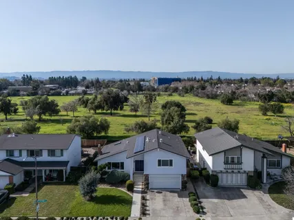 an aerial view of a house with a yard