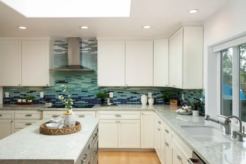 a kitchen with sink a stove and cabinets