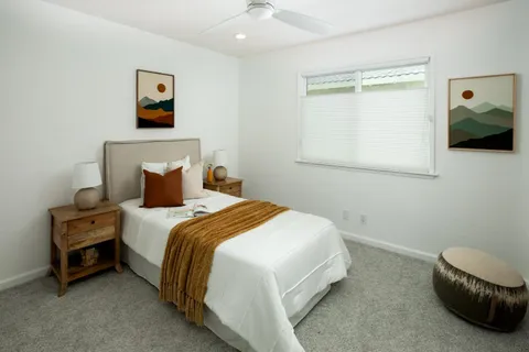 a bedroom with a bed and a window