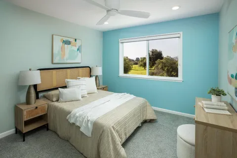 a bedroom with bed and a window