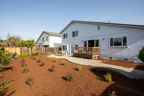 a view of a house with swimming pool and sitting area