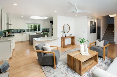 a living room with kitchen island furniture and a kitchen view