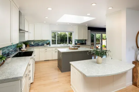 a kitchen with a sink a counter top space and appliances