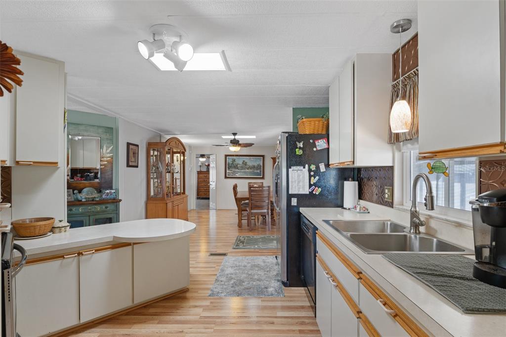 175 Martinique Road North Port, FL 34287 - Photo 13 of 82 a large kitchen with stainless steel appliances granite countertop a lot of counter space and wooden floor