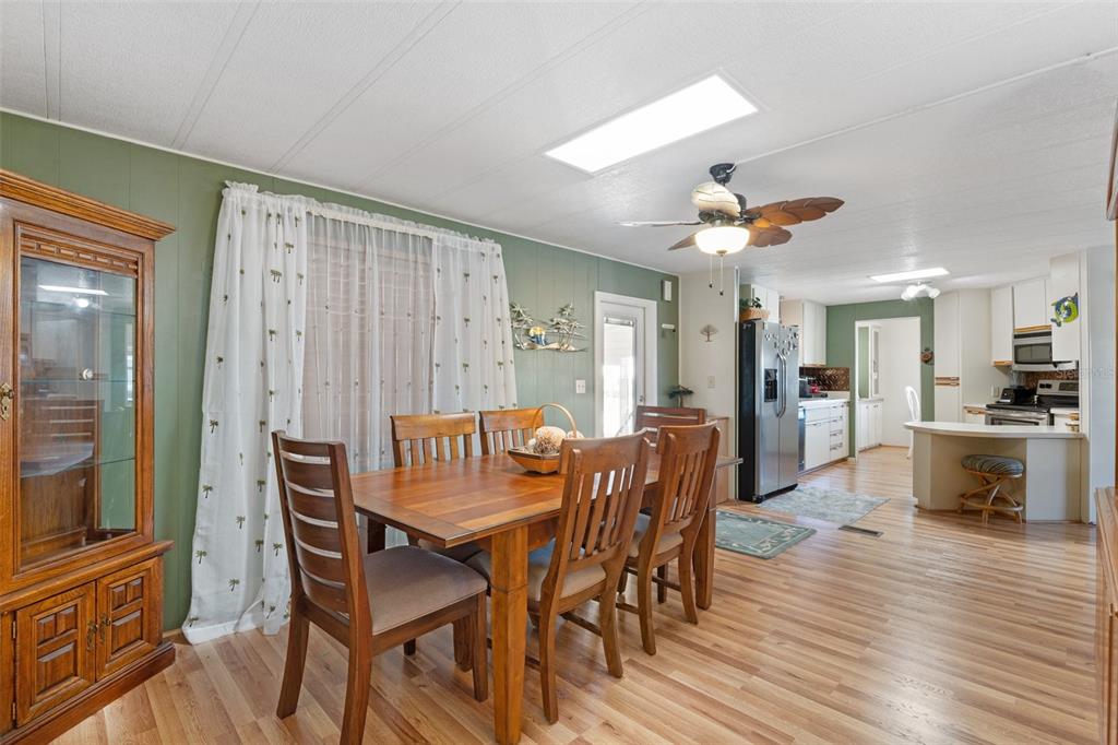 175 Martinique Road North Port, FL 34287 - Photo 27 of 82 a view of a dining room with furniture and wooden floor