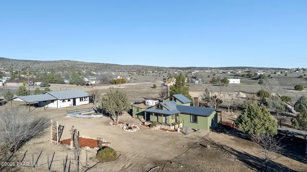 an aerial view of a house with a yard and lake view