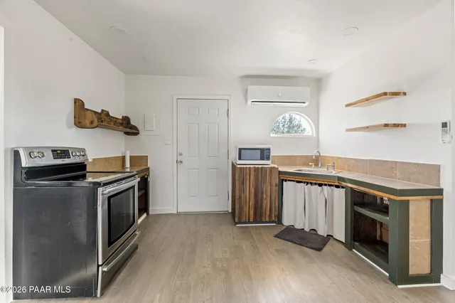 a kitchen with a stove and a microwave