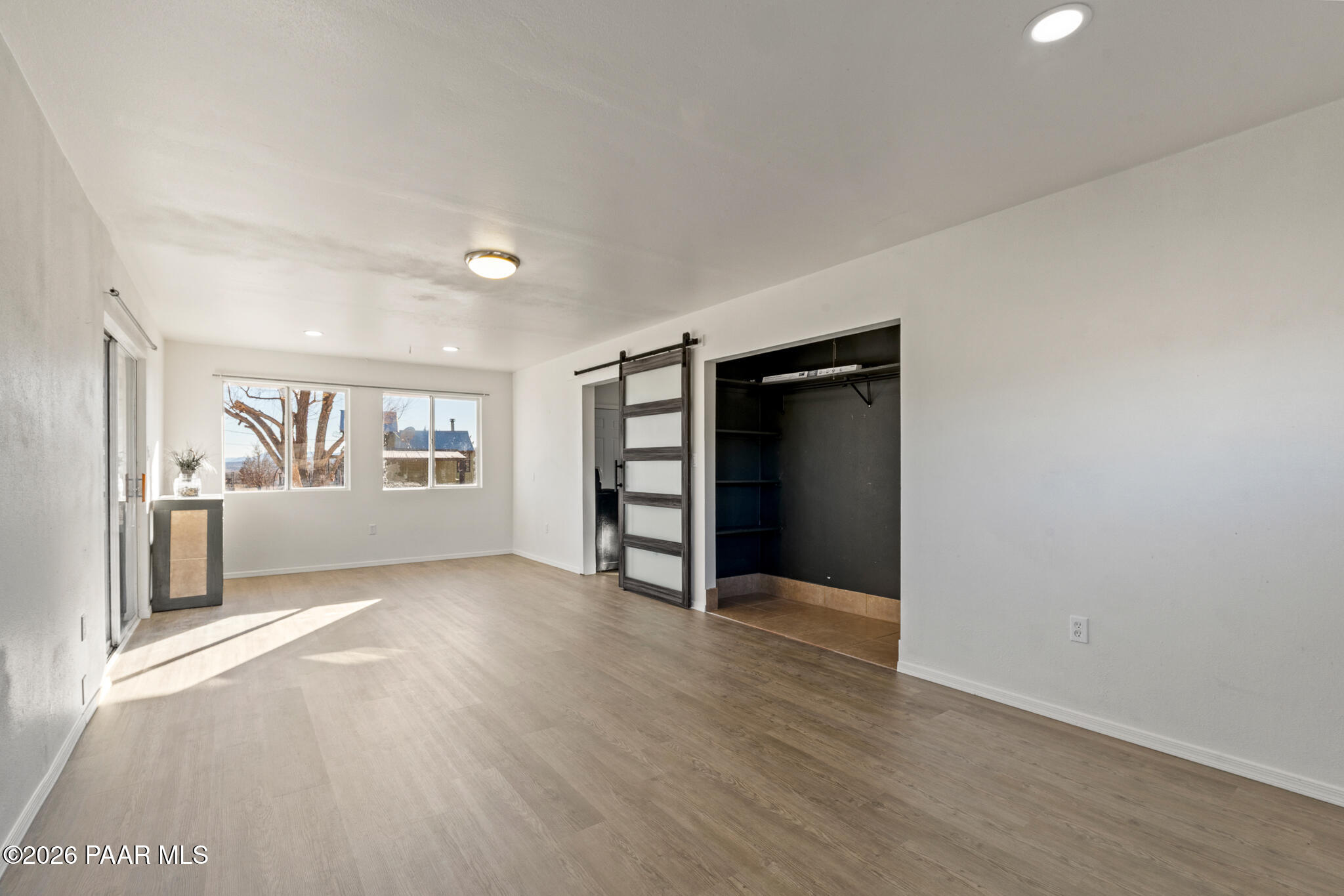 685 West Iris Road Paulden, AZ 86334 - Photo 9 of 33 a view of an empty room with a window and wooden floor