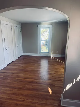 a view of room with window and wooden floor