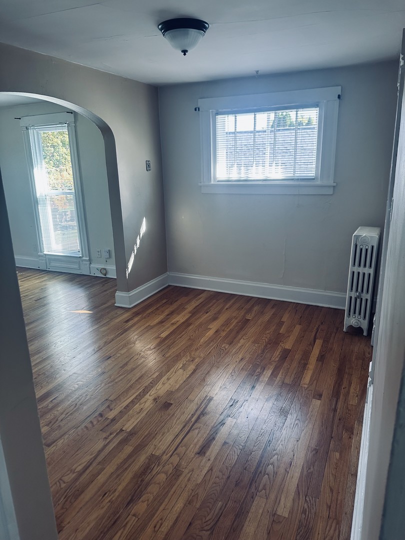 330 West Sycamore Street, Unit 2E Sycamore, IL 60178 - Photo 4 of 8 a view of empty room with wooden floor and fan