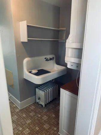 a kitchen with a sink and a refrigerator