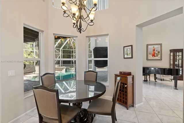 a kitchen with stainless steel appliances a stove center island a dining table and chairs