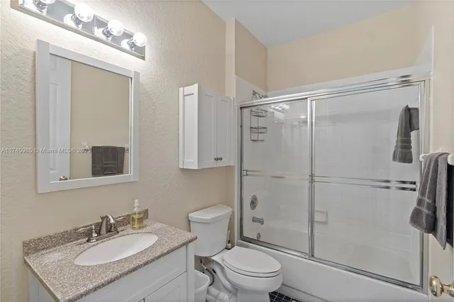 an aerial view of a houses with a lake and city view