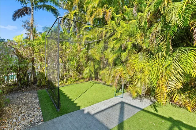 an aerial view of a house with a garden and lake view