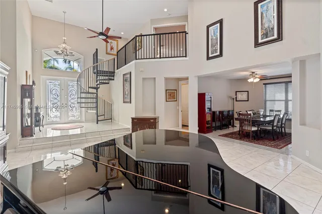 a kitchen with stainless steel appliances granite countertop a sink a counter space and living room view
