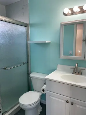 a white toilet sitting next to a bathroom sink