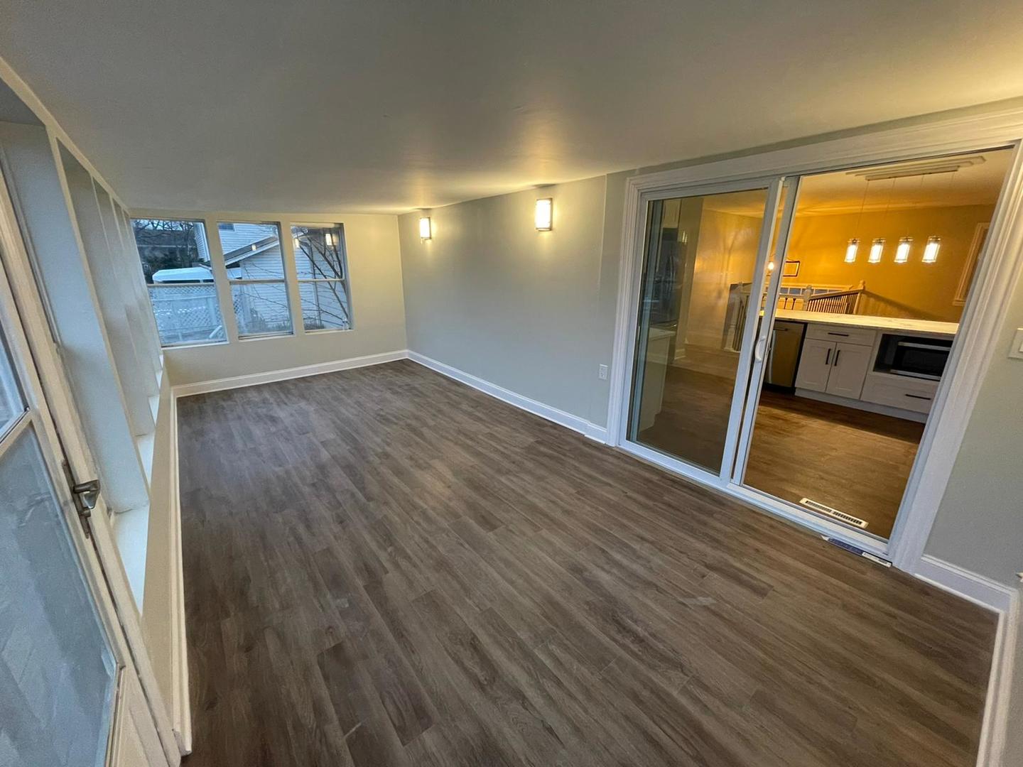 725 North Rohlwing Road Palatine, IL 60074 - Photo 5 of 27 a view of an empty room with wooden floor and a window