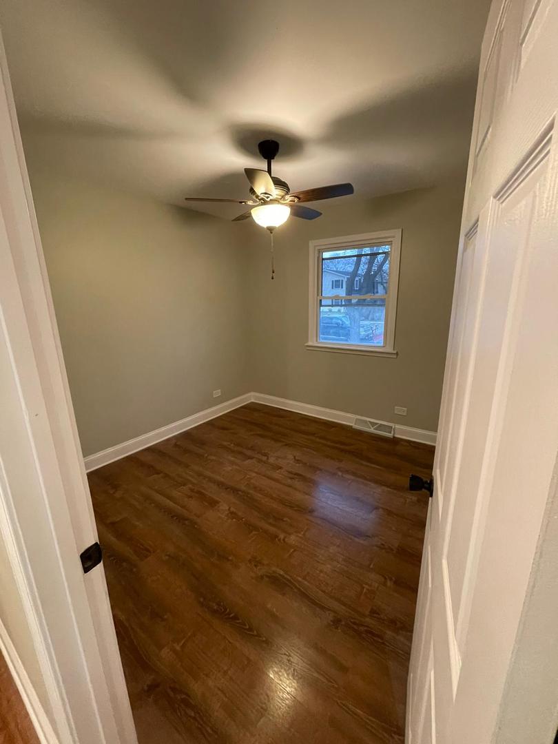 725 North Rohlwing Road Palatine, IL 60074 - Photo 6 of 27 an empty room with a fan and a window
