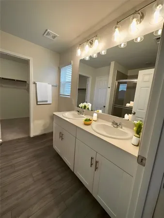 a bathroom with a double vanity sink and a mirror