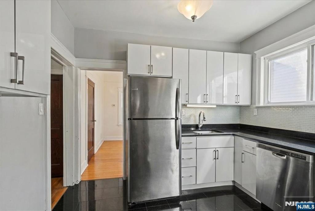 436 Undercliff Avenue Edgewater, NJ 07020 - Photo 17 of 33 a white refrigerator freezer sitting inside of a kitchen