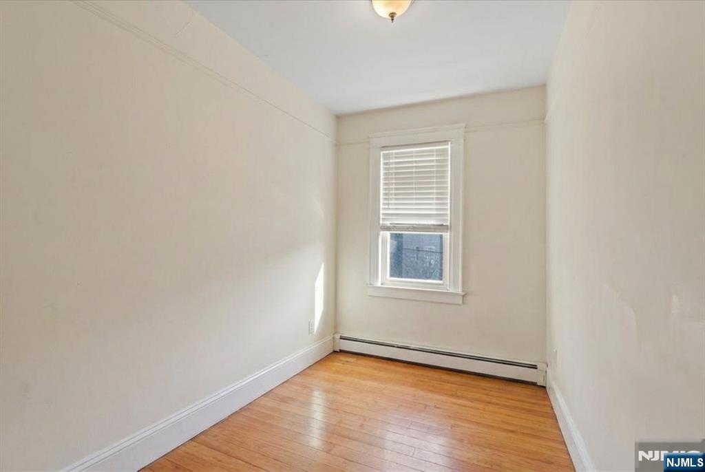436 Undercliff Avenue Edgewater, NJ 07020 - Photo 20 of 33 an empty room with wooden floor and windows