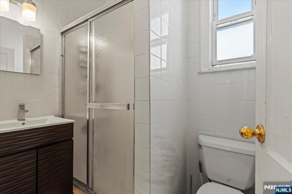 436 Undercliff Avenue Edgewater, NJ 07020 - Photo 21 of 33 a bathroom with a sink a toilet and a mirror