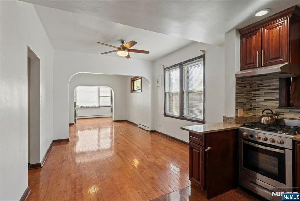 436 Undercliff Avenue Edgewater, NJ 07020 - Photo 3 of 33 a kitchen with stainless steel appliances a stove a sink and a microwave