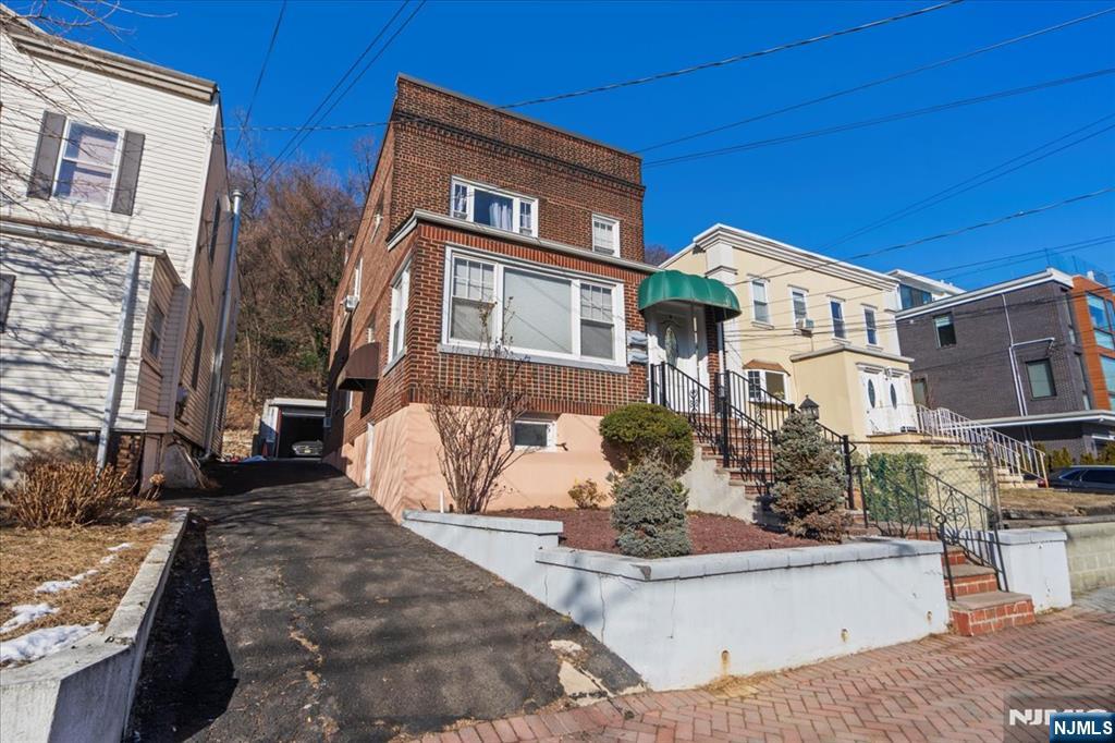 436 Undercliff Avenue Edgewater, NJ 07020 - Photo 33 of 33 a front view of a house with a yard