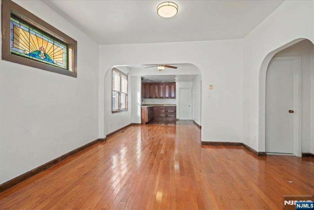 436 Undercliff Avenue Edgewater, NJ 07020 - Photo 5 of 33 a view of empty room with wooden floor and fan