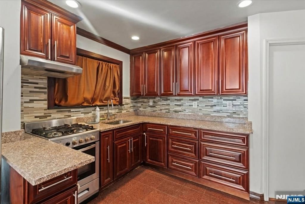 436 Undercliff Avenue Edgewater, NJ 07020 - Photo 6 of 33 a kitchen that has a sink and a stove in it