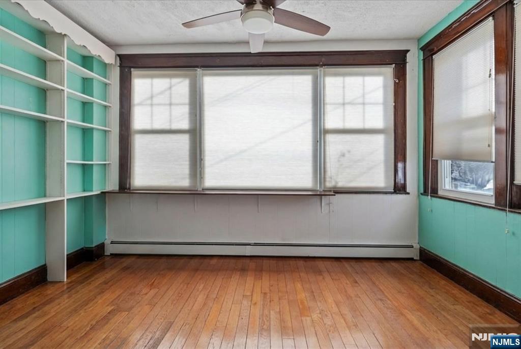 436 Undercliff Avenue Edgewater, NJ 07020 - Photo 9 of 33 a view of a room with wooden floor and a window