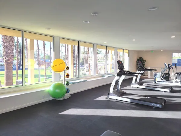 a view of a room with gym equipment and windows