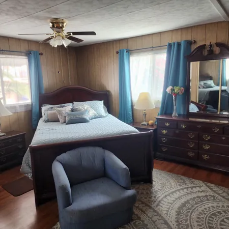 a bedroom with bed and window with lamp