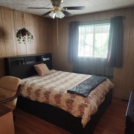 a bed sitting in a bedroom next to a window