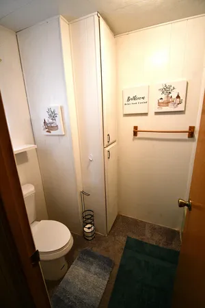 a bathroom with a toilet and a shower