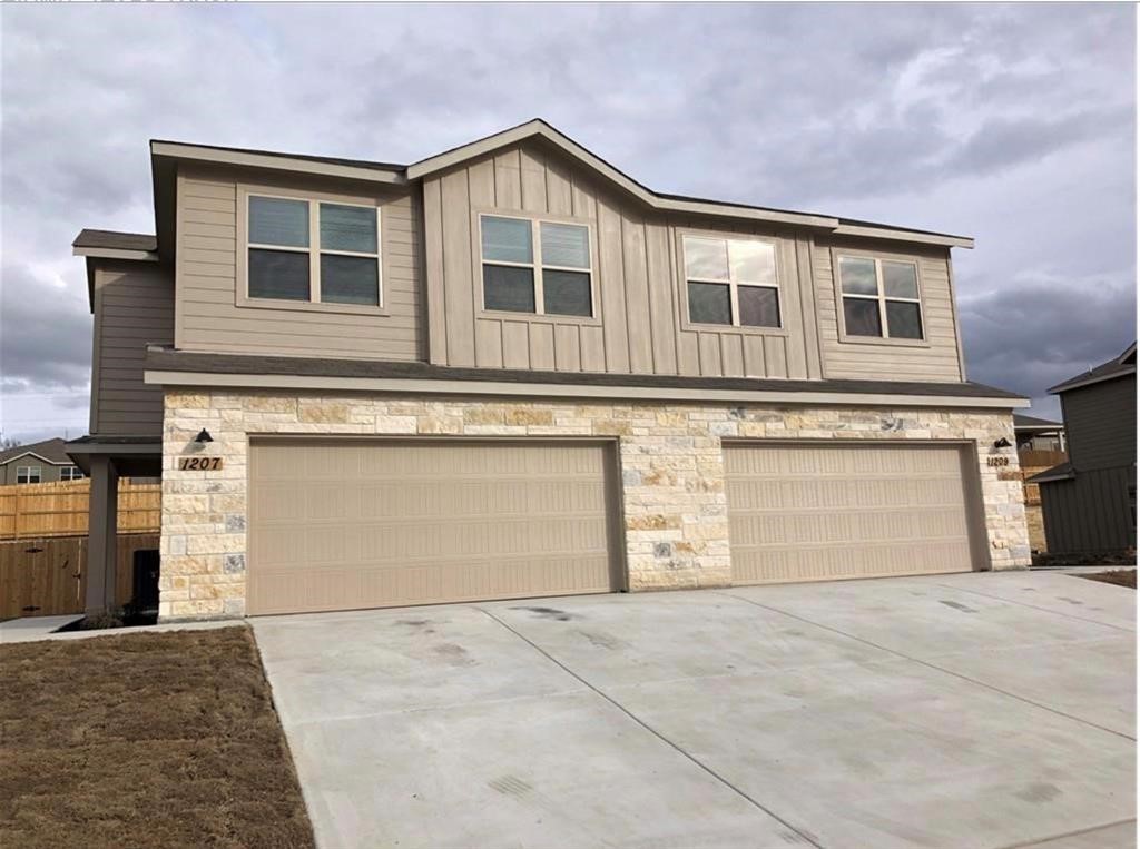 1207 Garland Road Georgetown, TX 78626 - Photo 2 of 10 a front view of a house with a yard and garage