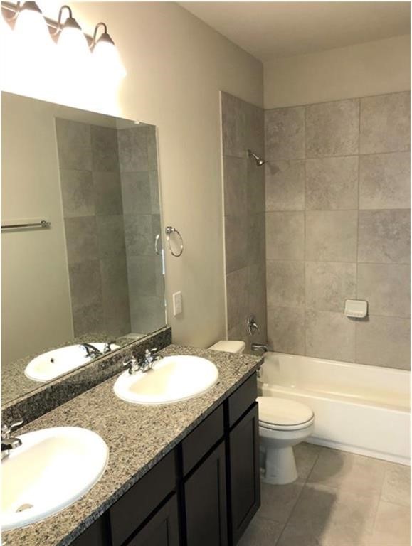 1207 Garland Road Georgetown, TX 78626 - Photo 8 of 10 a bathroom with a granite countertop sink toilet and shower