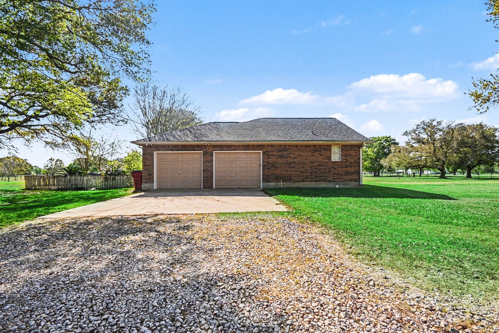 21503 Pecan Bend Road Damon, TX 77430 - Photo 6 of 45 a front view of a house with a yard and garage