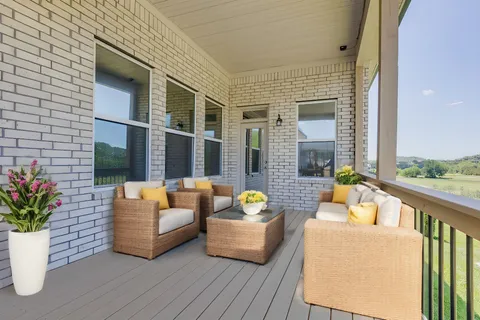 a balcony with furniture and a potted plant
